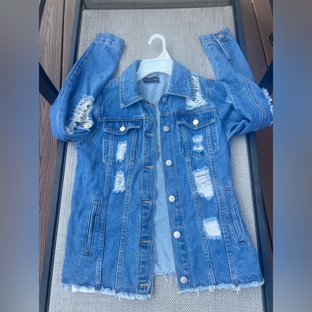 Distressed jean jacket size small with buttons and pockets